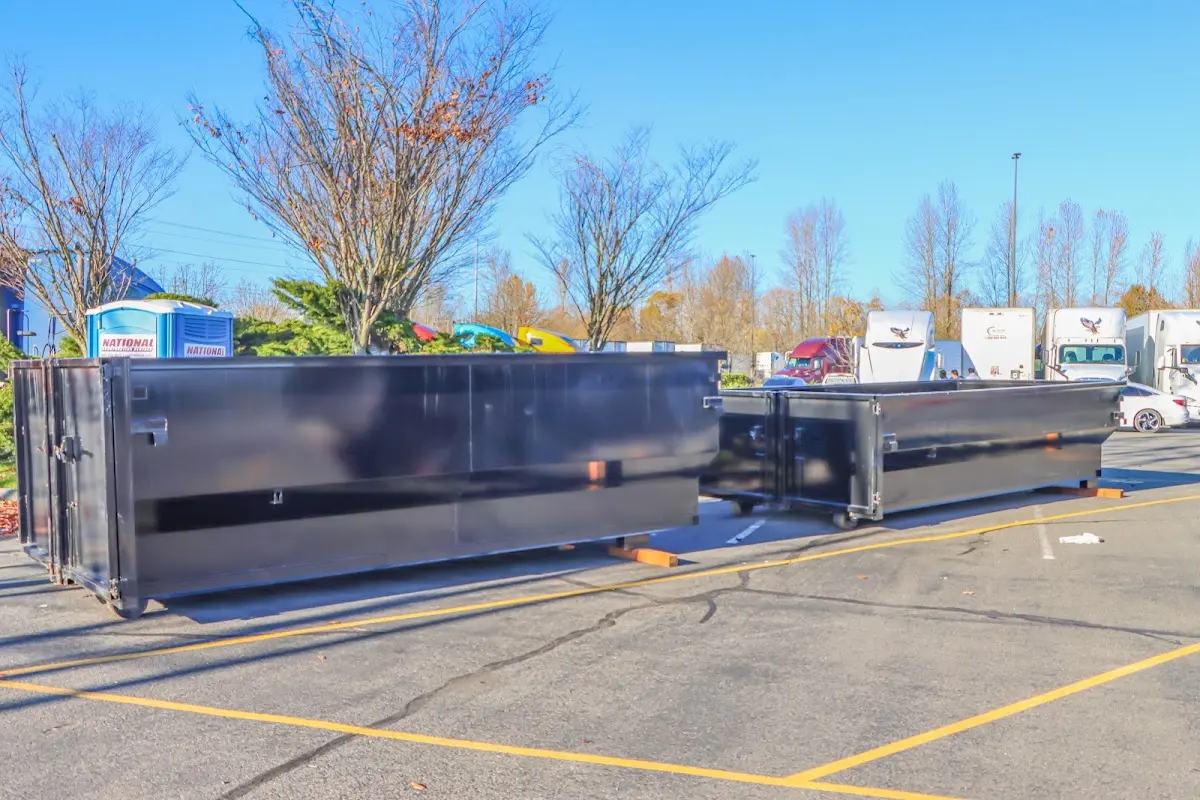 Professional dumpster rental service with roll-off container on residential driveway in Eagle Lake